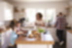 A family together in the kitchen having breakfast