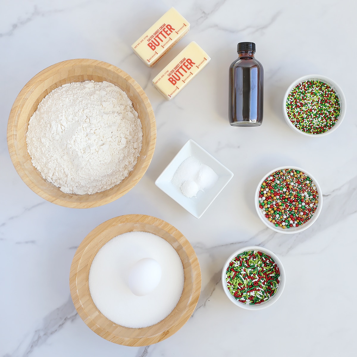 Ingredients you need to make easy christmas sugar cookies with sprinkles.