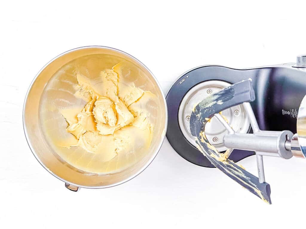 Butter and sugar creamed together in the bowl of a stand mixer.