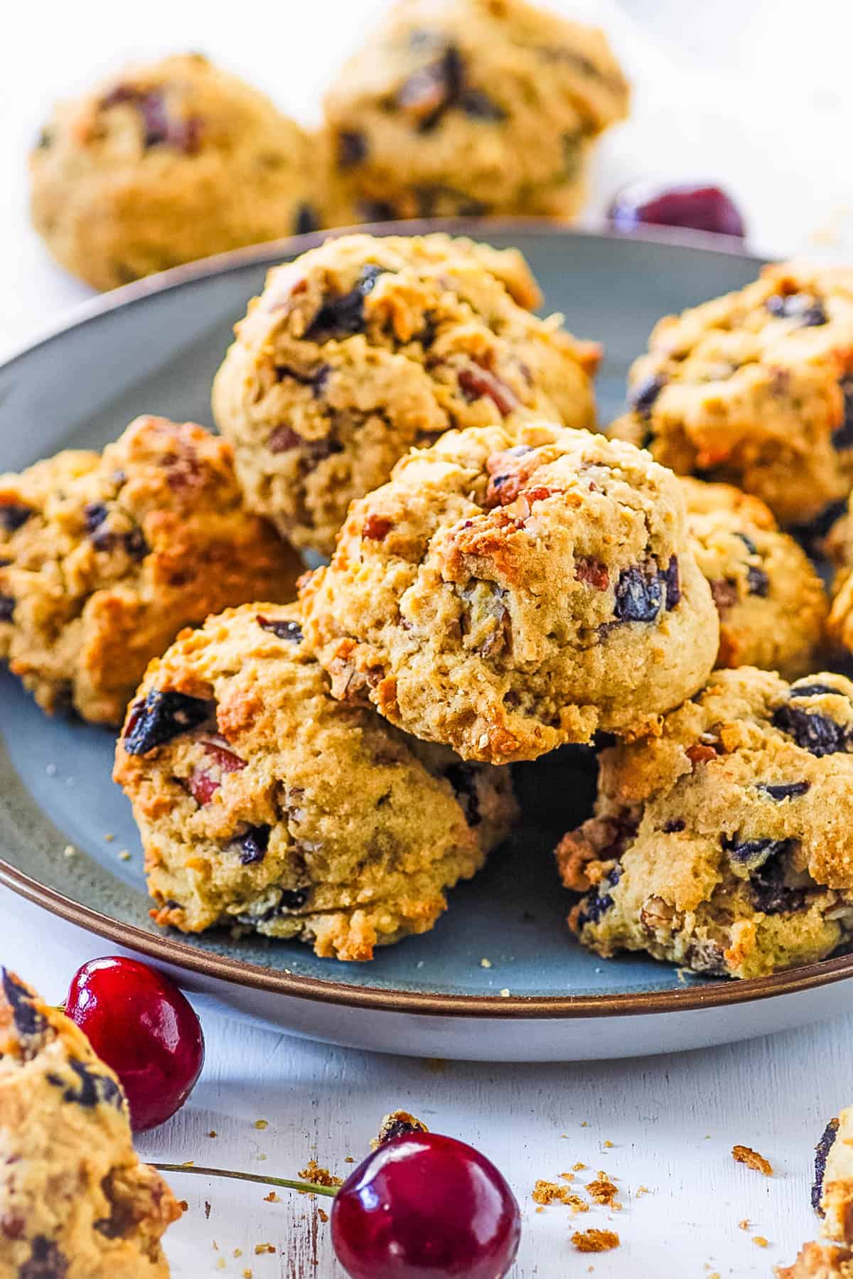 Dried fruit cookies stacked on a blue plate.