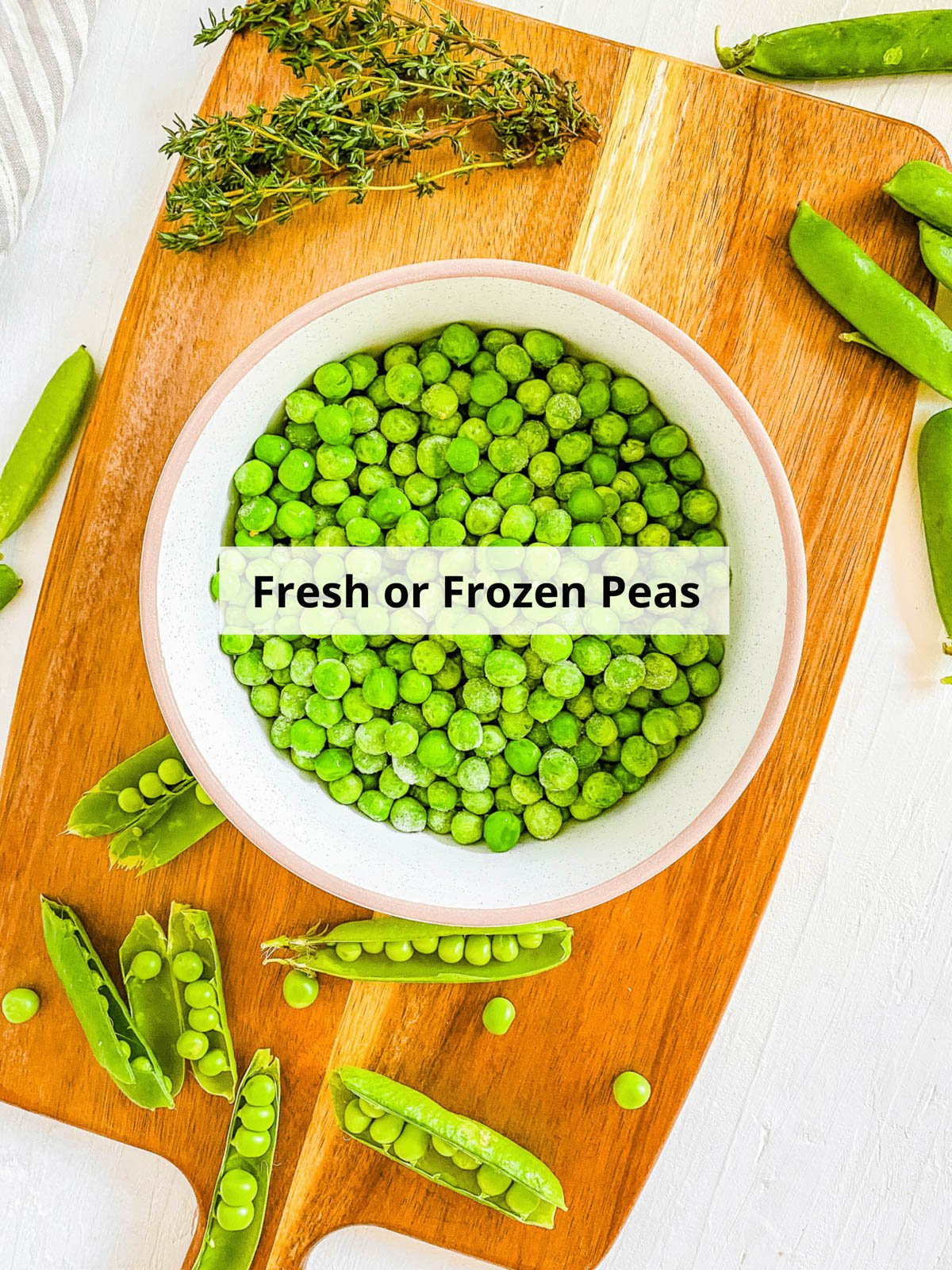 Ingredients for peas baby food recipe on a wood cutting board.