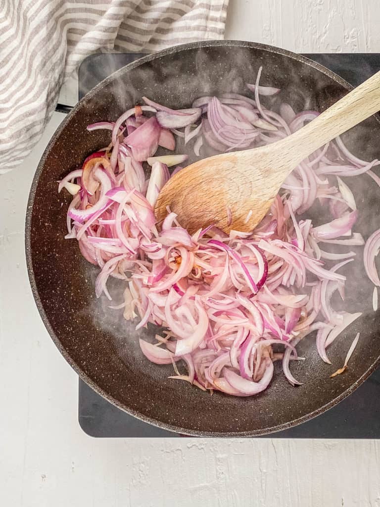 onions sauteeing in a pan