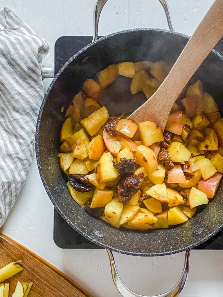 apples and prunes cooking in a large pot