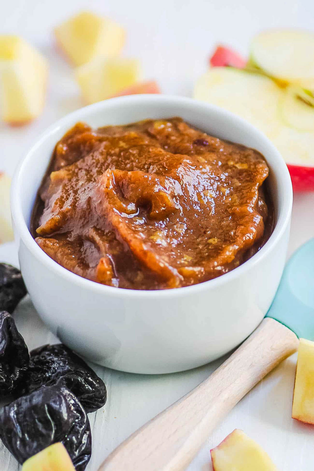 Prune puree for baby served in a white bowl.