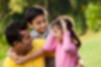 Father with son and daughter outside and all smiling