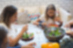 A mom and daughter eating salad