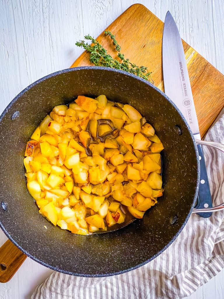 Cut pears steaming in a large pot on the stove.