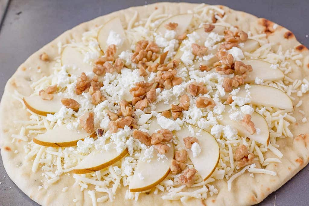 pears walnuts and cheese on pizza dough