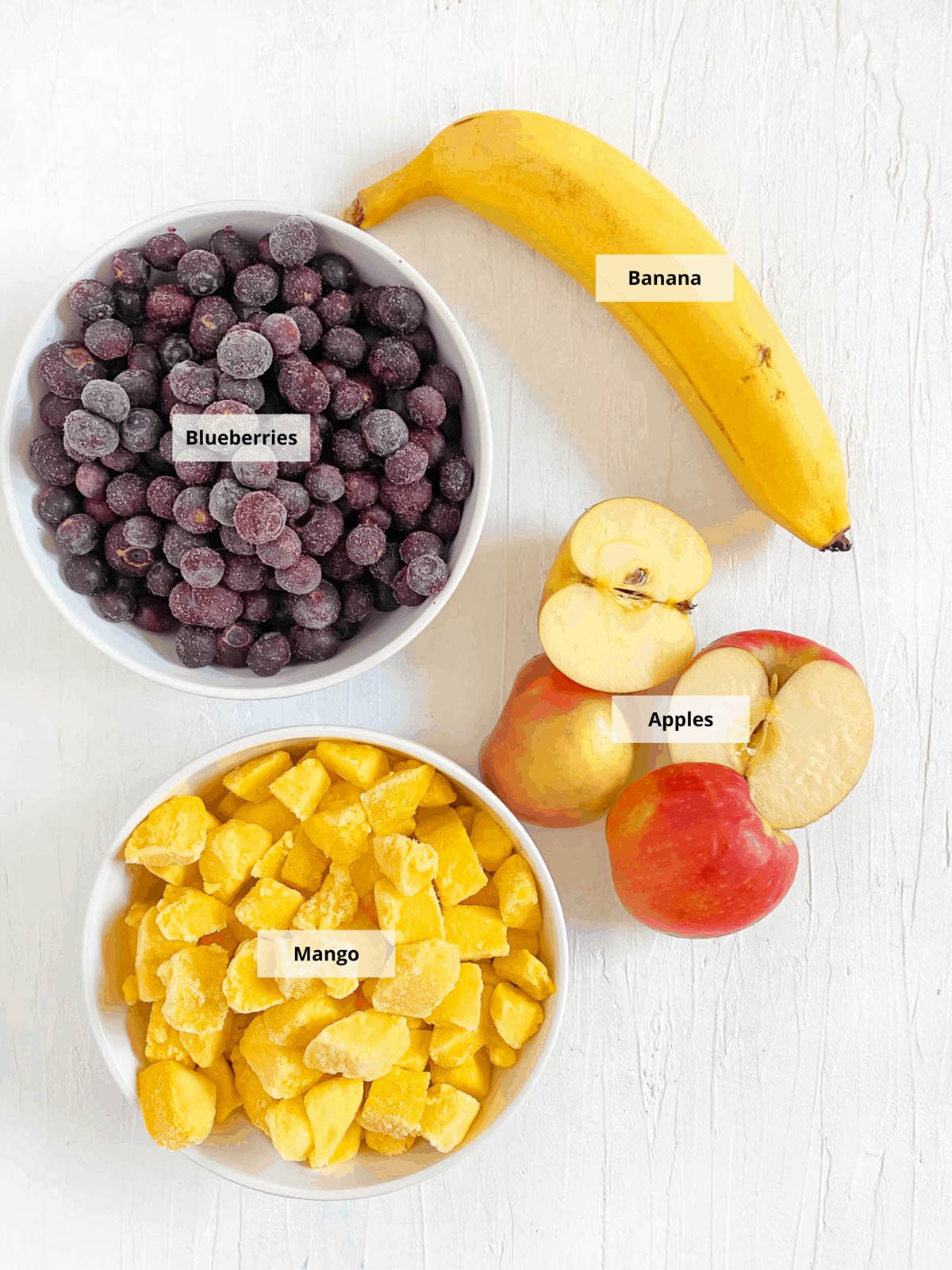 Ingredients for blueberry baby food recipe on a white background.