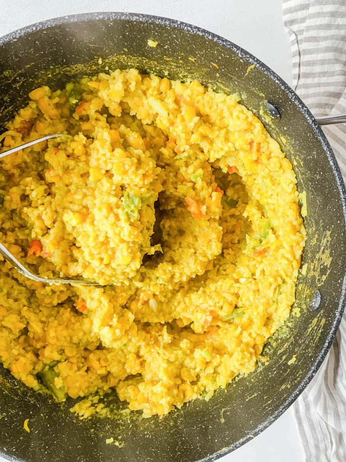 Baby lentils recipe with veggies served in a large pot.